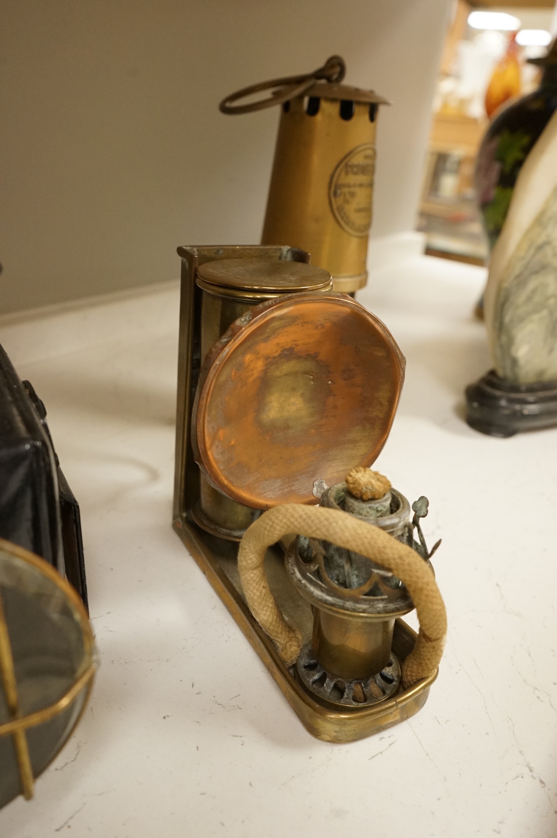 A railway lamp, a vintage Eccles Protector miners lamp and another, largest 17cm high